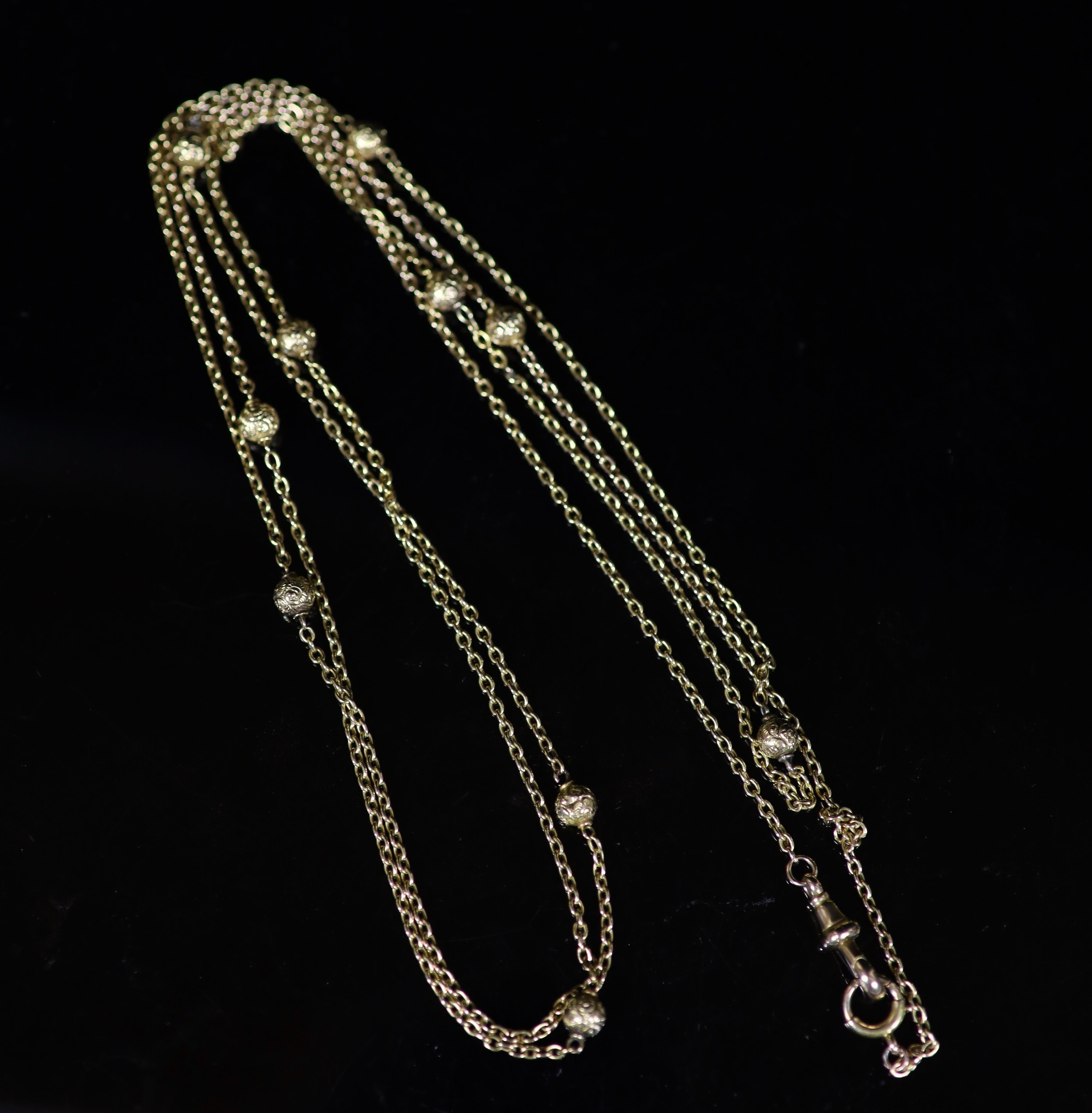 An early 20th century 15ct gold chain link and engraved bead guard chain, 135cm